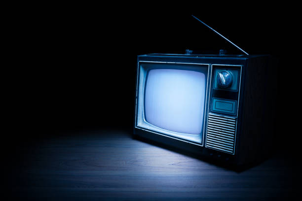 istock Vintage TV with static on white wooden background 1019113218