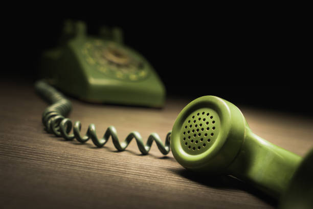 istock Old rotary telephone on wooden surface 1019126436