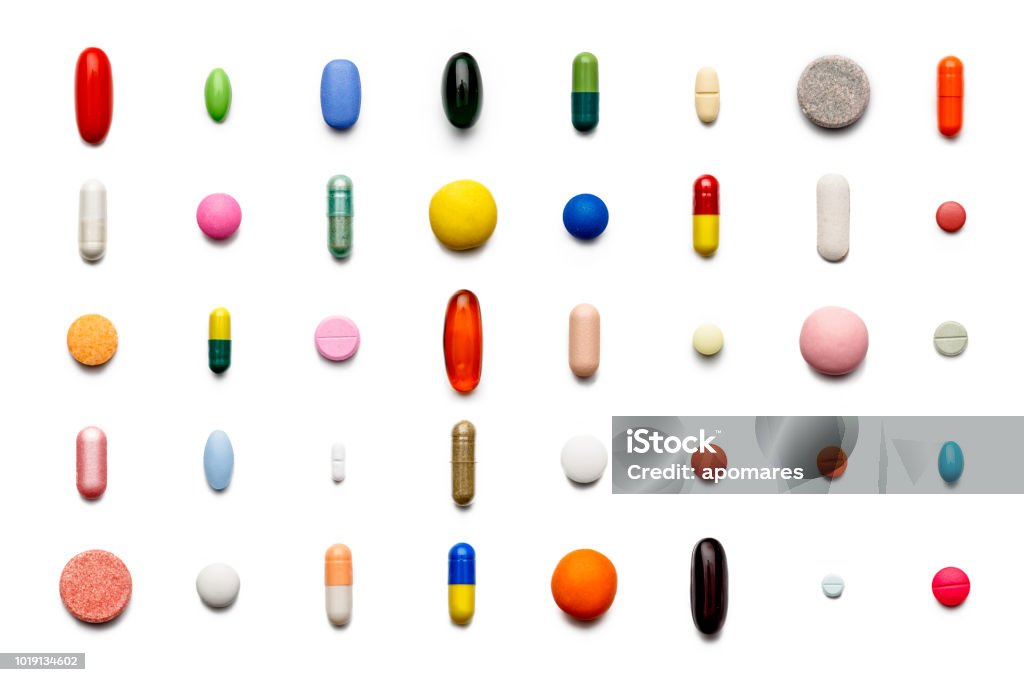 Array of large group of assorted capsules and pills on white background. High resolution image. Pill Stock Photo