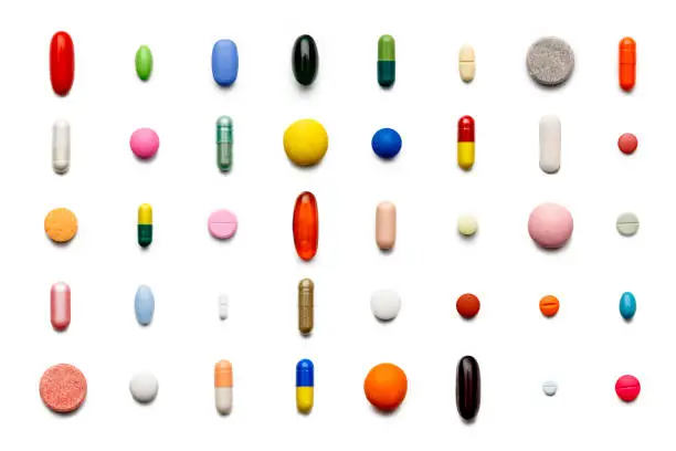 Photo of Array of large group of assorted capsules and pills on white background. High resolution image.
