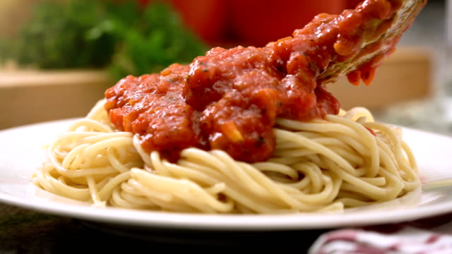 Eating spaghetti with tomato sauce Italian food