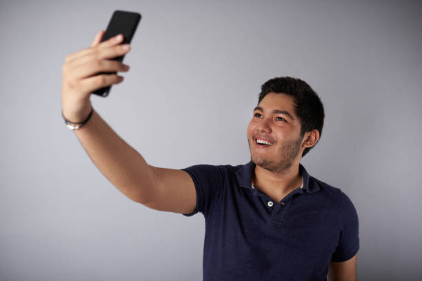 istock Happy smiling young man taking selfie 1019139080
