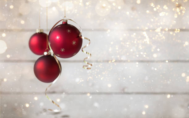 christmas holiday baubles with gold ribbon against an old wooden background - ribbon curled up hanging christmas imagens e fotografias de stock