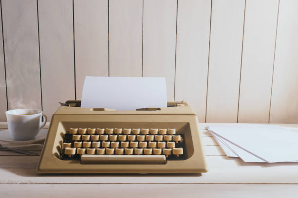 istock Vintage typewriter with accessories on wooden desk 1019143998