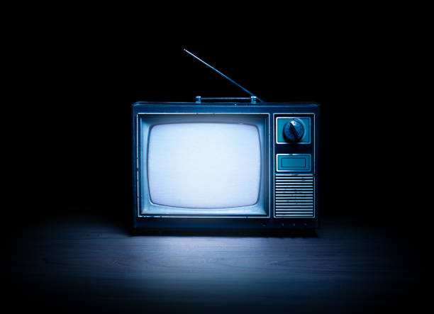 istock Vintage TV with static on white wooden background 1019151428