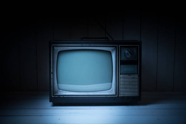 istock Vintage TV with static on white wooden background 1019153464