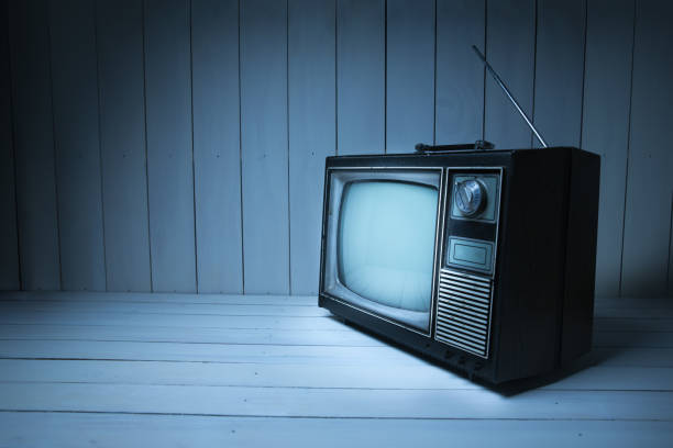 istock Vintage TV with static on white wooden background 1019153806