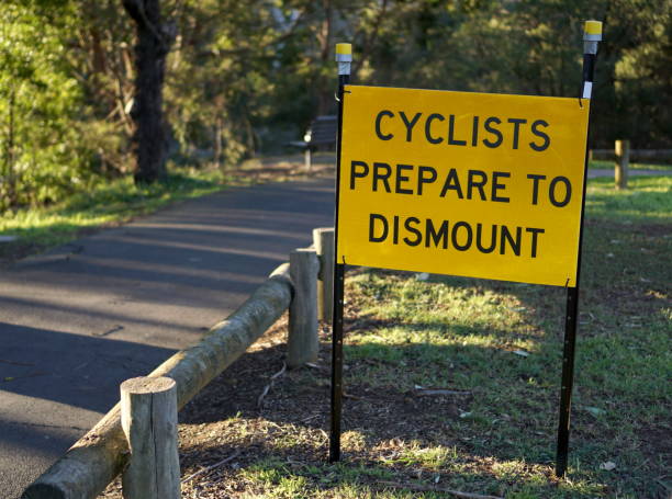 istock Cyclists prepare to dismount sign 1019167602