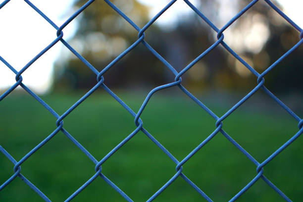 istock Crooked line of chain link fence 1019168154