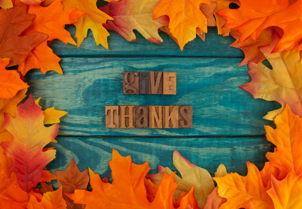 istock Give Thanks Background with Fall Leaves on Blue Wood 1019172522