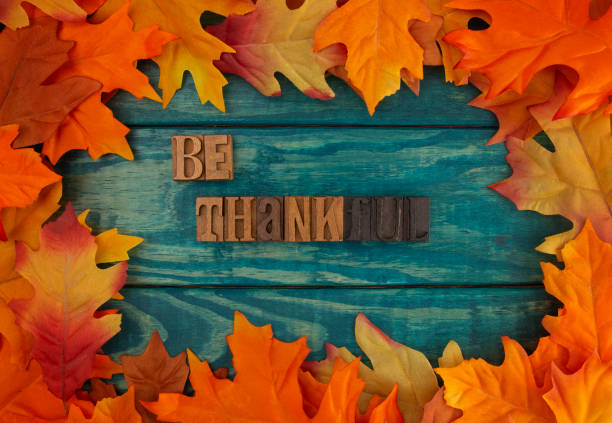 istock Be Thankful Background with Fall Leaves on Blue Wood 1019172528