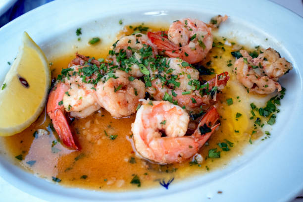 Sauted Shrimp Scampi in a lemon butter cream sauce on a plate at an outdoor cafe
