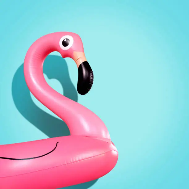 Giant inflatable Flamingo on a blue background, pool float party, trendy summer concept