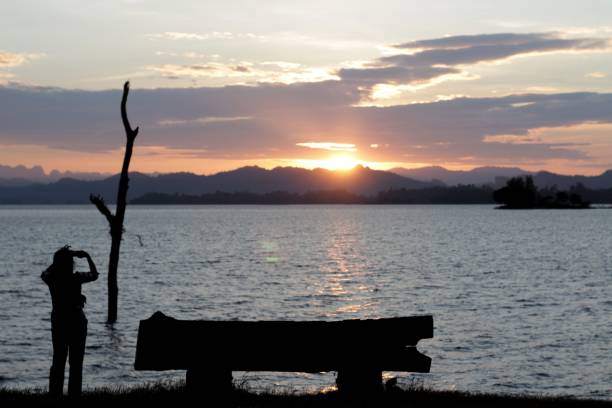 istock A woman take photos the sunset view 1019197434