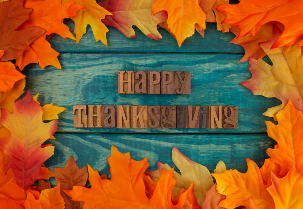 istock Happy Thanksgiving Background with Fall Leaves on Blue Wood 1019199722