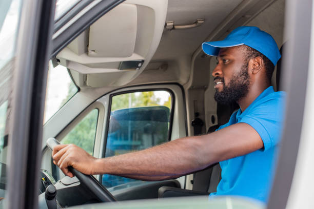 istock side view of african american delivery man driving van 1019214018