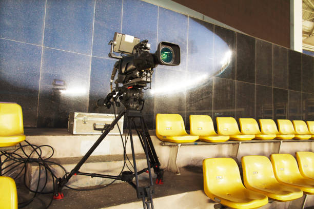 istock Professional TV camera filming event in a stadium 1019214380