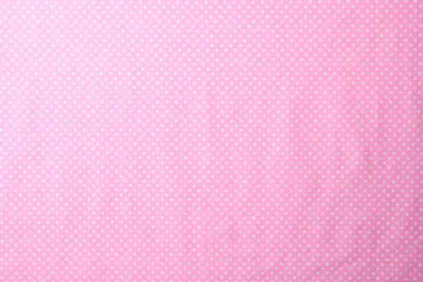 Photo of Pink polka dot fabric texture background