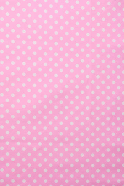 istock Close-up of pink polka dot fabric texture background 1019217370