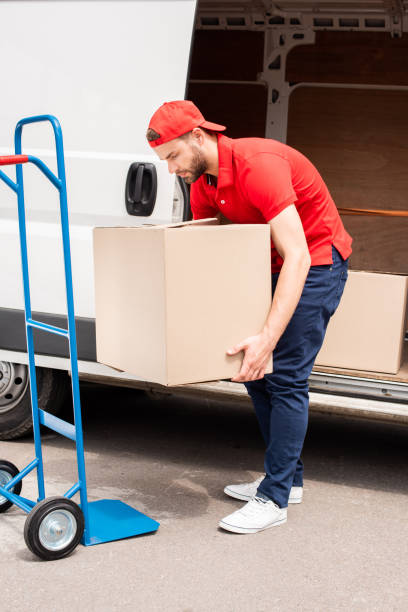 istock young delivery man discharging cardboard boxes from van 1019217488