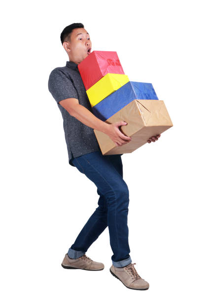 若い男の贈り物のキャリング ボックス - christmas stack gift carrying ストックフォトと画像