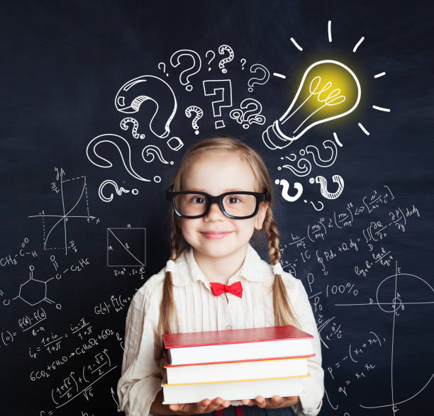 istock Elementary school student girl with proud expression showing his ideas over his head. Kid holding books 1019219718