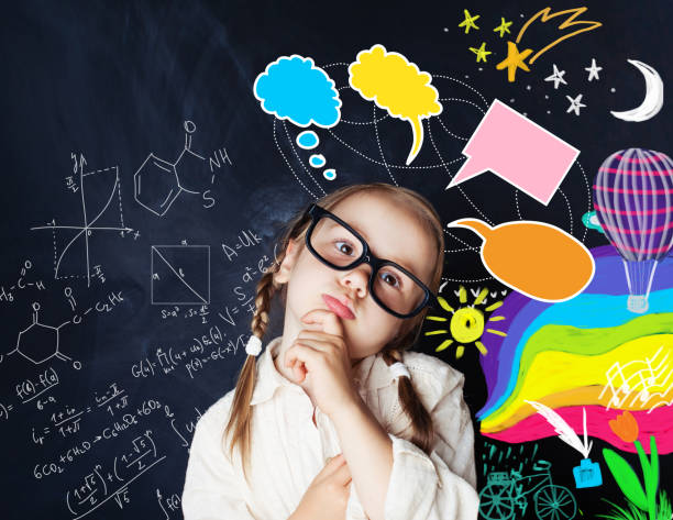 istock Smart kid with speech bubbles and colorful creative design elements and science formulas on chalk board 1019219858