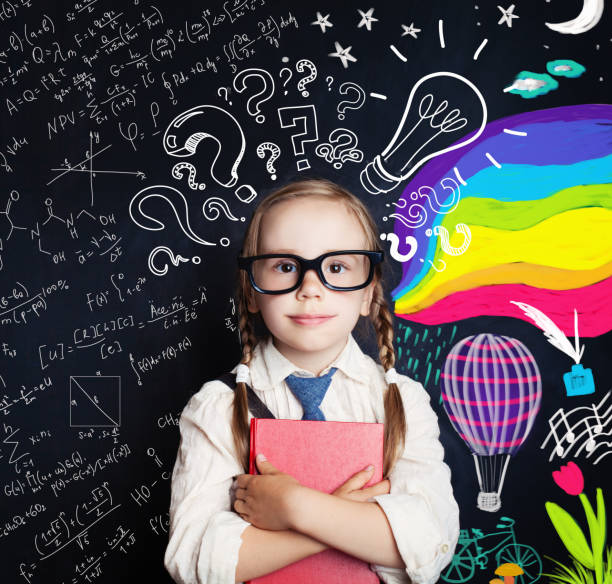 istock Creativity education, new ideas and right and left hemispheres of the brain concept. Smiling little girl on blackboard background with math and art pattern 1019219940