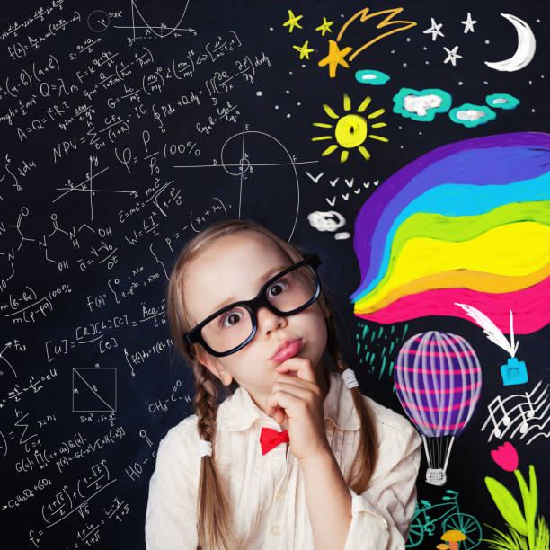 istock Creativity education and child ideas concept. Thinking schoolgirl on blackboard background with chalk math and colorful art pattern 1019219948