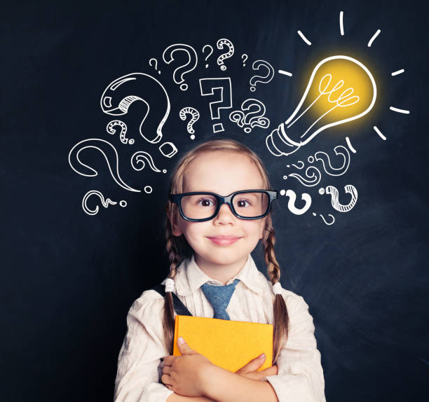 istock Child ideas. Smiling child school student with yellow book, lightbulb and chalk question marks. Brainstorm, problem and solution 1019219970