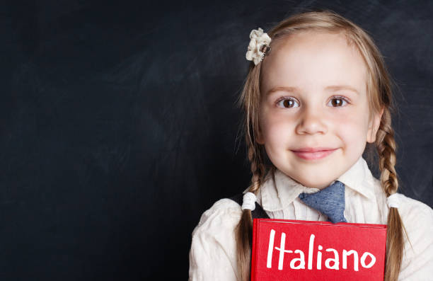 istock Schoolgirl student learning italian with Italiano book 1019220216