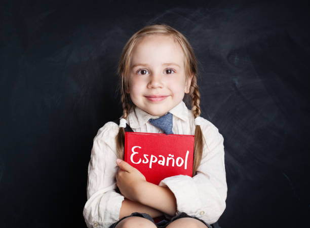 istock Kid learning spanish. Little girl with spanish book 1019220248