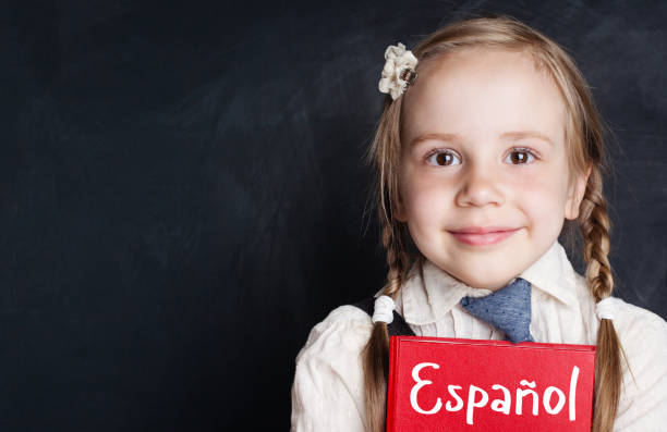 istock Small child student learning spanish at the classroom chalkboard banner background with copy space 1019220292
