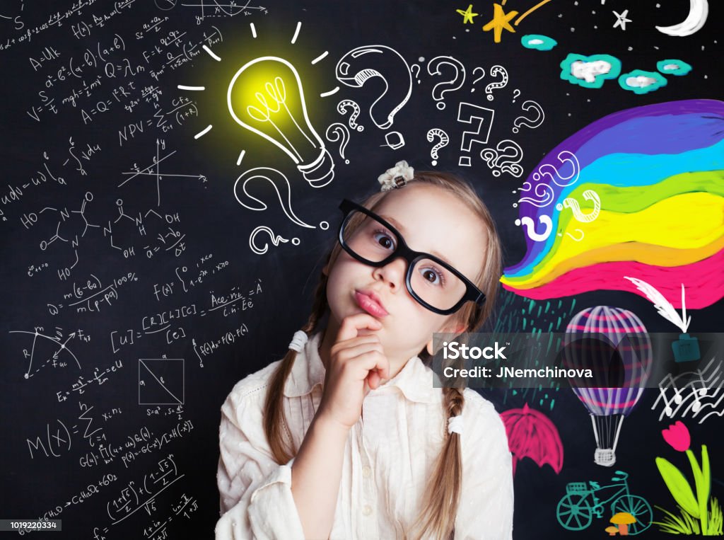 Pensive child school student with yellow lightbulb and school and childhood supplies design elements. Child ideas and development concept Child Stock Photo