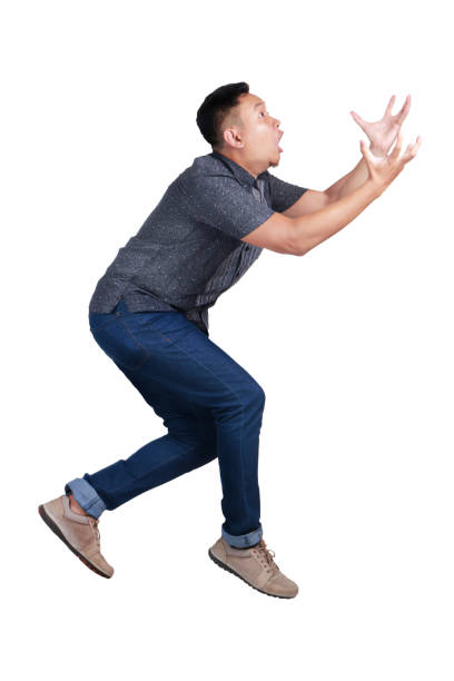 istock Young Man Reach Something that Falls from Above. Side View 1019220342