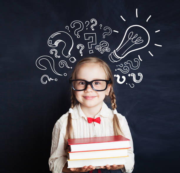 istock Cheerful child school girl student with stack of book, lightbulb and chalk question marks. Brainstorm, problem and solution concept 1019220350
