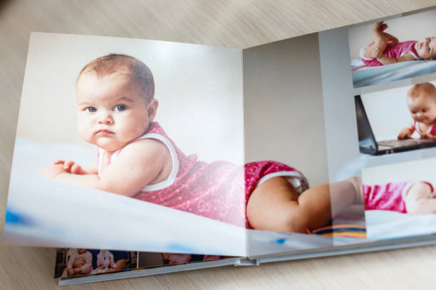 istock High angle view open book with album at home 1019237544