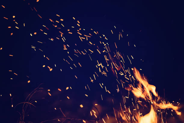 Photo of Night bonfire with sparks. Fire background with copyspace