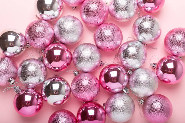 istock Pink and silver christmas balls on a paper background 1019241212