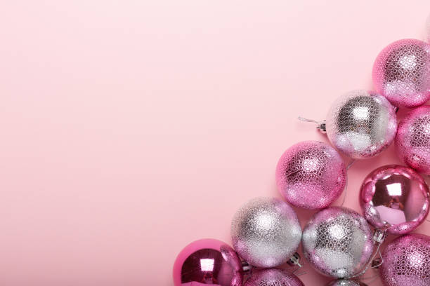 istock Pink and silver christmas balls on a paper background 1019241468