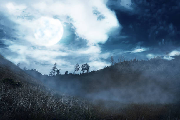istock Misty hill with dark cloud and full moon on the night 1019242274