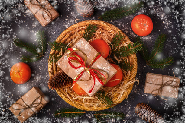 istock Christmas composition with tangerines, gift boxes, cones on dark  background. 1019243798