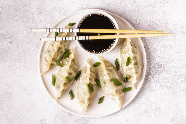 istock Asian dumplings, soy sauce, chopsticks 1019244424