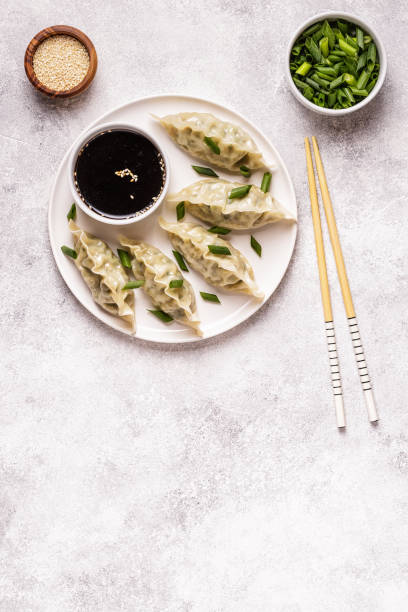 istock Asian dumplings, soy sauce, chopsticks 1019244434