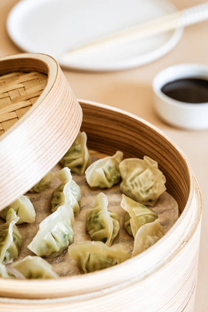 istock Asian gyoza, dumplings snack, chopsticks, steamer 1019244476