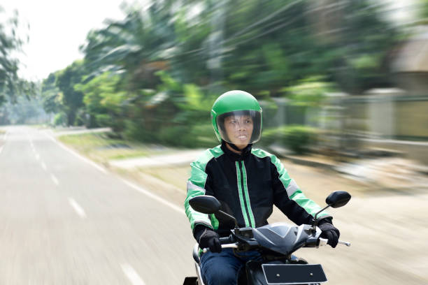 istock Young man working as motorcycle taxi driver 1019244568