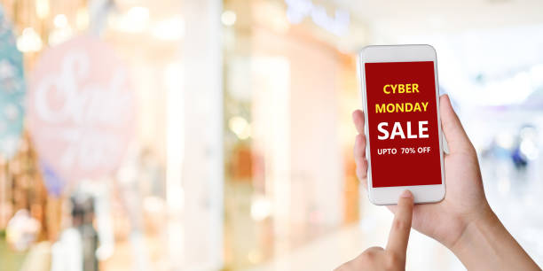 istock Hand using smart phone with cyber monday sale on screen device over blur background with copy space, business technology and lifestyle concept 1019248548