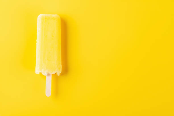 istock yellow popsicle on a yellow background 1019251498