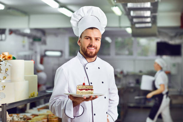 A confectioner with dessert in his hands stock photo
