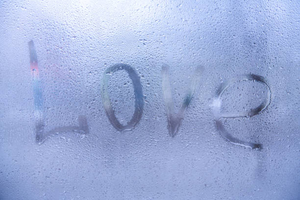 istock The word Love , rain or water drops on window glasses. 1019251992